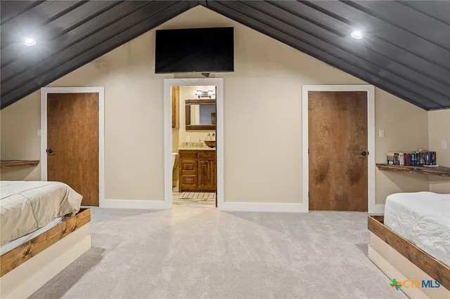 a bedroom with a large bed and a chandelier