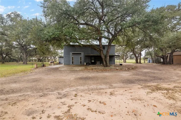 a view of a house with a yard and garage