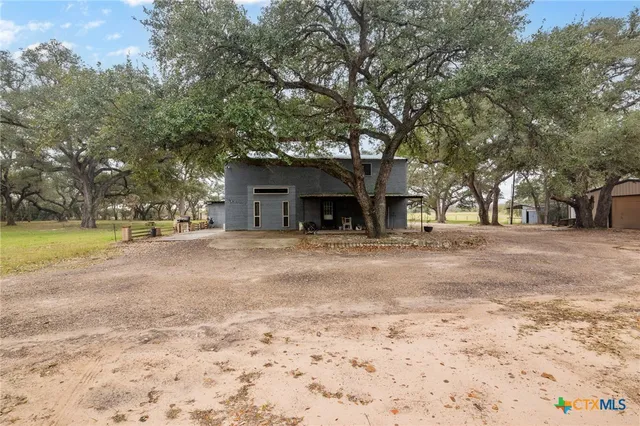 a view of a house with a yard and garage