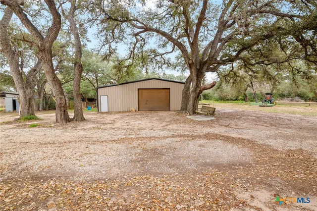 a view of a backyard with large trees