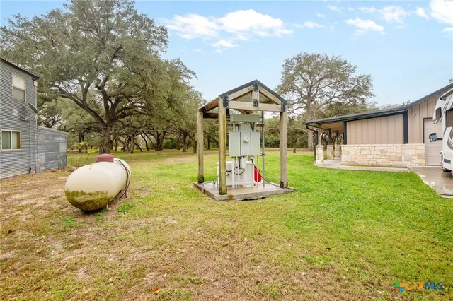a view of a wooden house and a yard