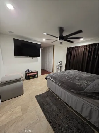 a bedroom with bed and a chandelier