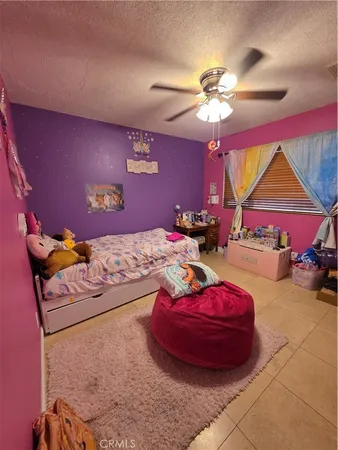 a bedroom with a bed dresser and a dining table
