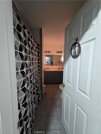 a utility room with a sink a toilet and a mirror