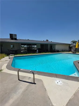 a view of swimming pool with a yard