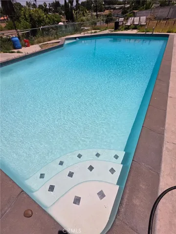 a view of a swimming pool with a deck