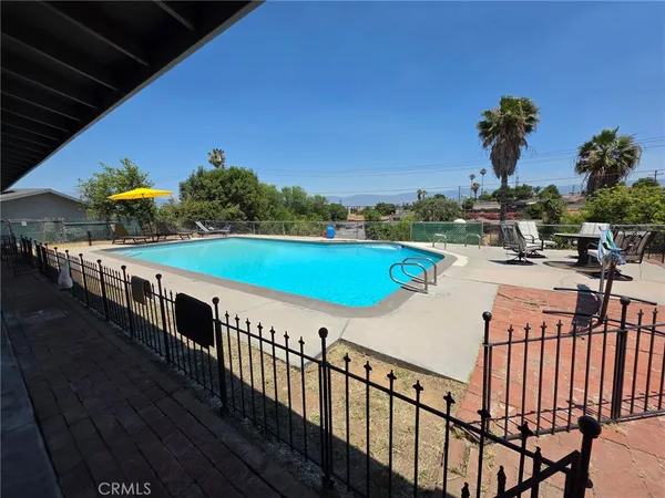 a view of swimming pool with outdoor seating