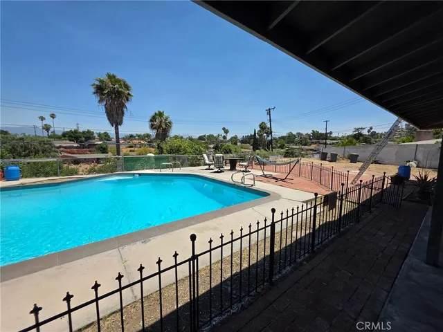 an empty room with sliding door and wooden floor