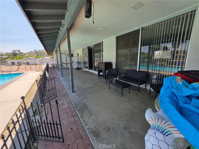 a swimming pool with outdoor seating and yard