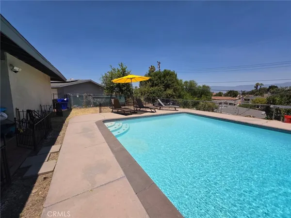 a swimming pool with outdoor seating and yard
