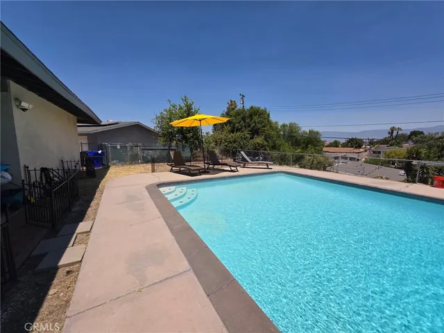 an empty room with sliding door and wooden floor