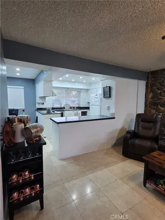 a kitchen with stainless steel appliances granite countertop a stove top oven a sink a counter space and cabinets