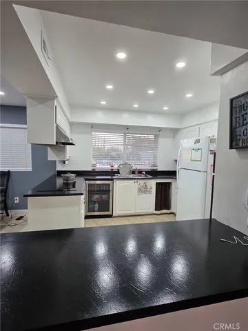 a living room with furniture a flat screen tv and a window