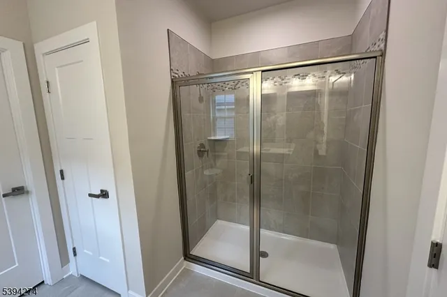a bathroom with a glass shower door