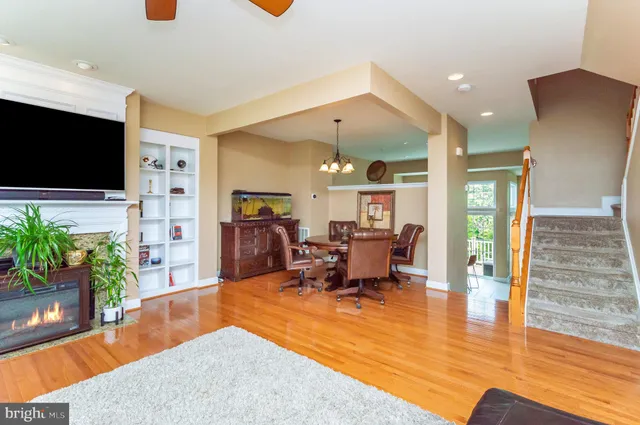 a living room with furniture wooden floor and a flat screen tv