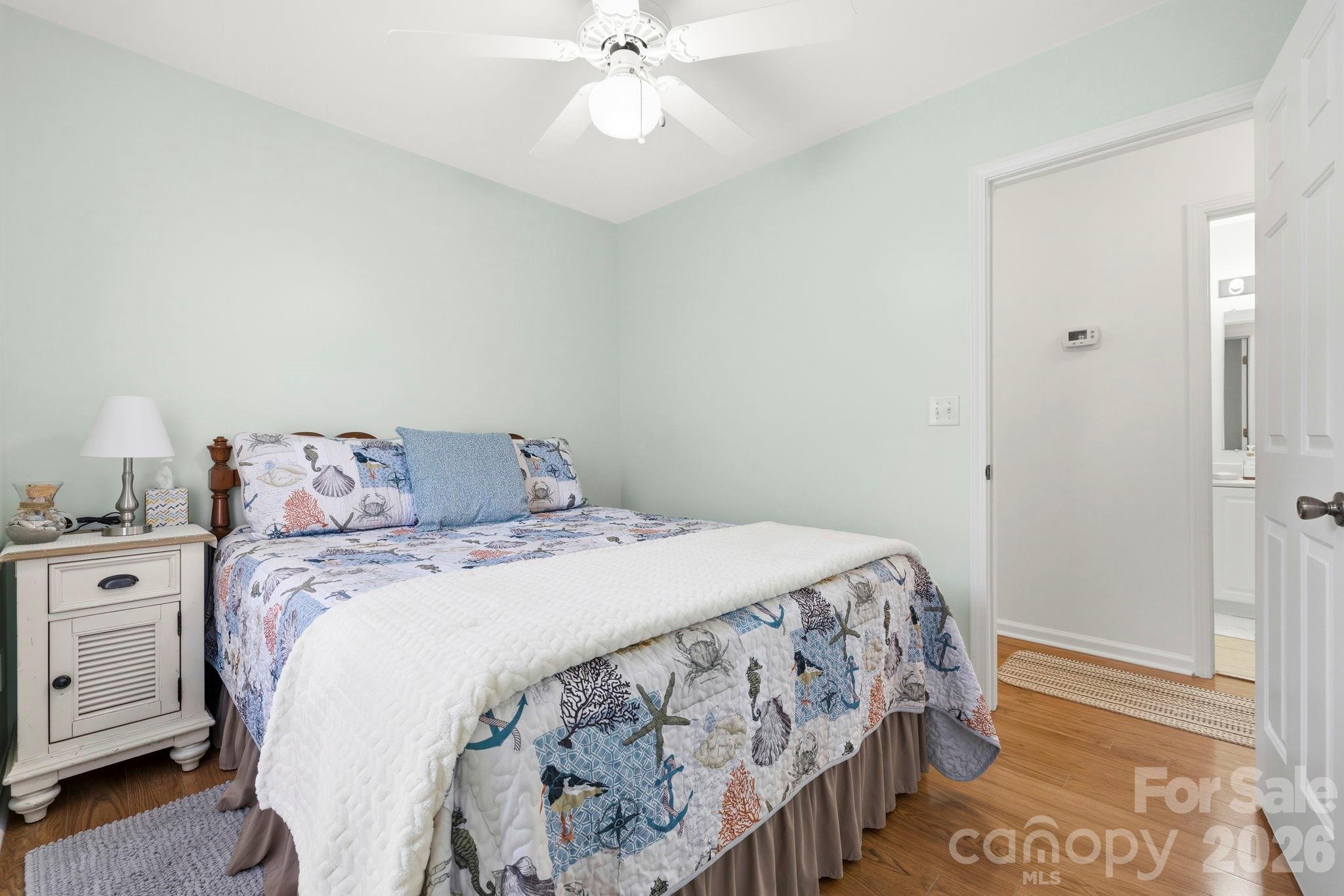 1539 Schooner Court Murrells Inlet, SC 29576 - Photo 17 of 28 a bedroom with a bed and a chandelier