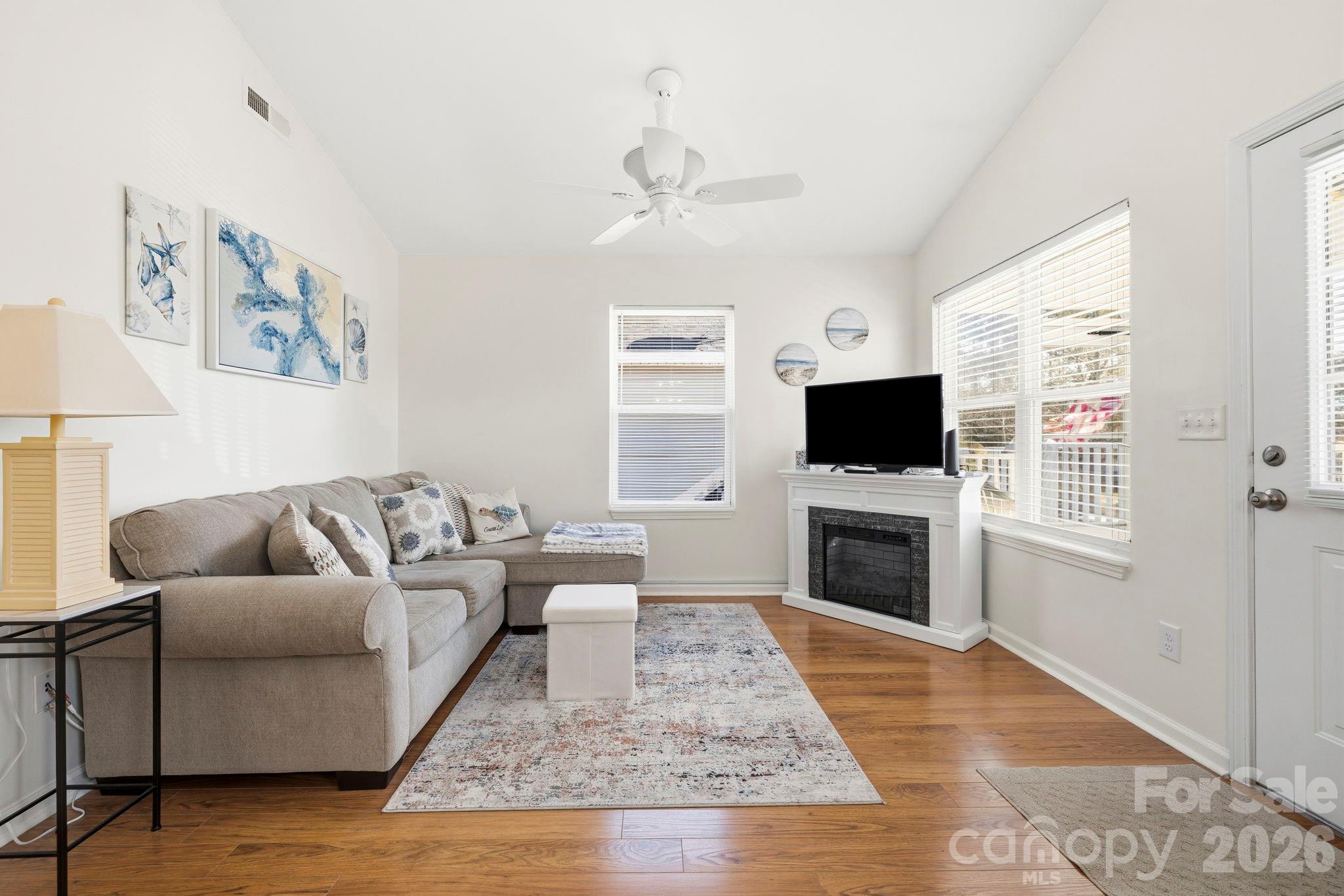 1539 Schooner Court Murrells Inlet, SC 29576 - Photo 5 of 28 a living room with furniture a flat screen tv and a fireplace