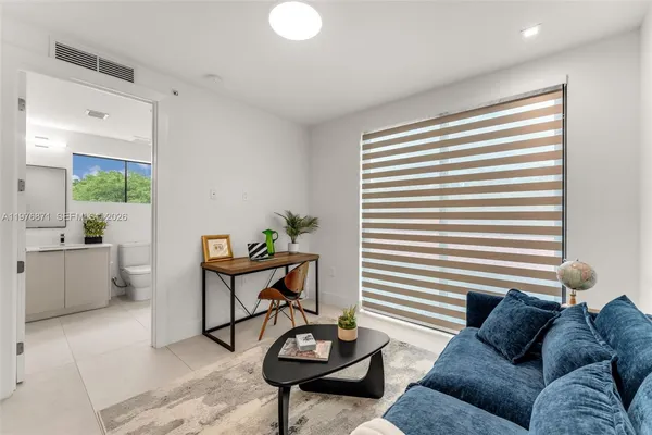 a living room with furniture and a potted plant