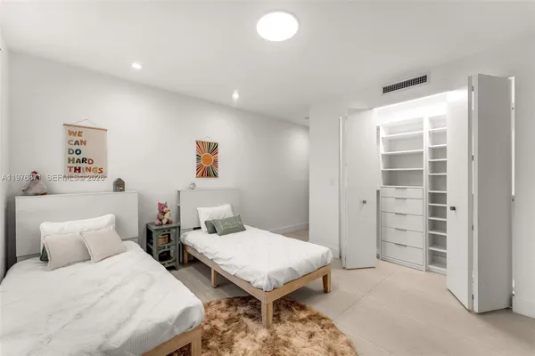 a bedroom with a bed and dresser