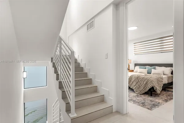 a view of bedroom with furniture and staircase