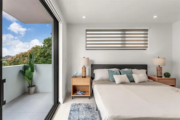 a bedroom with a bed and a balcony