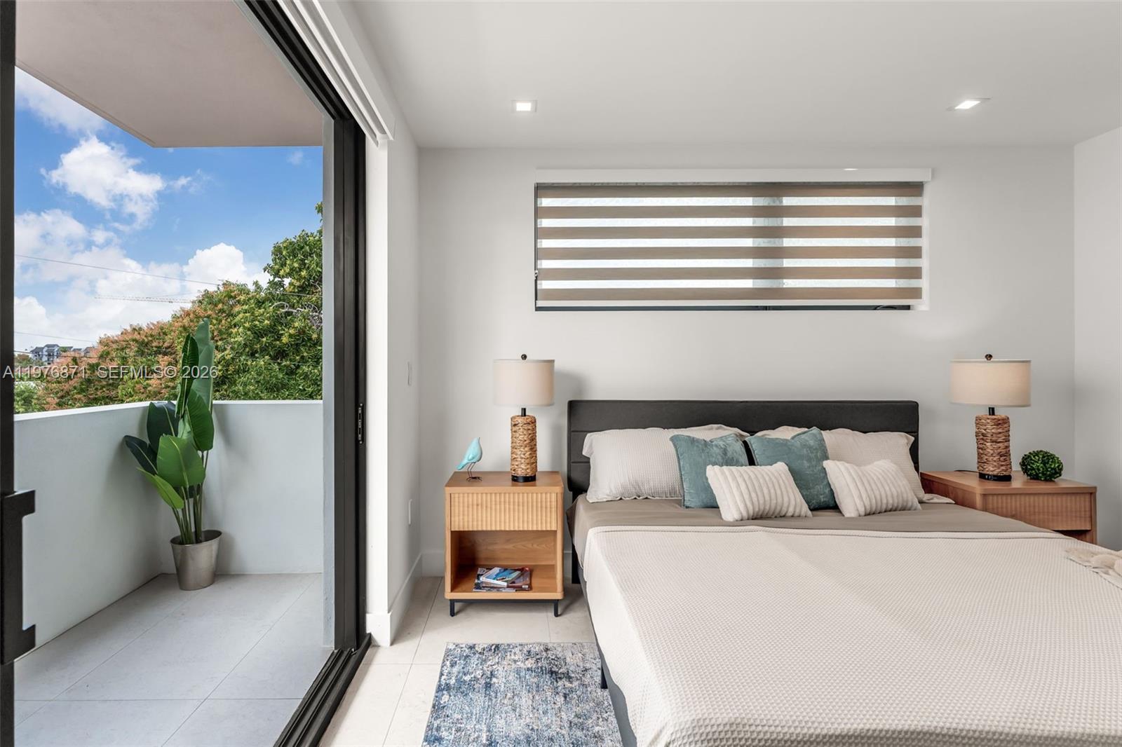 721 Southwest 11th Street, Unit F Miami, FL 33129 - Photo 18 of 36 a bedroom with a bed and a balcony