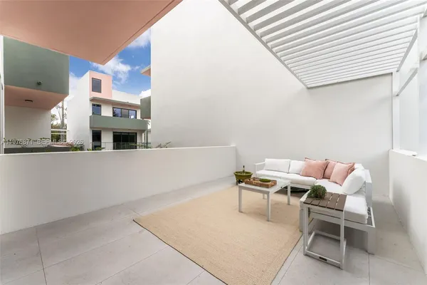 a balcony with chairs and a table