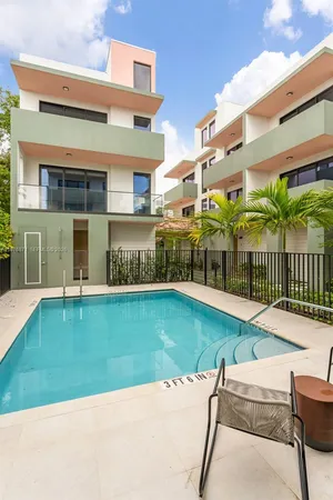 a house with swimming pool in front of it