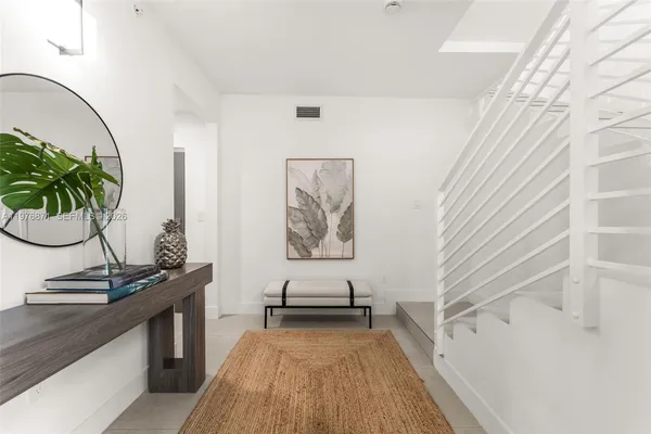 a view of a bedroom with a table and chair
