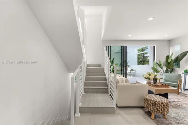 a living room with furniture and a entryway