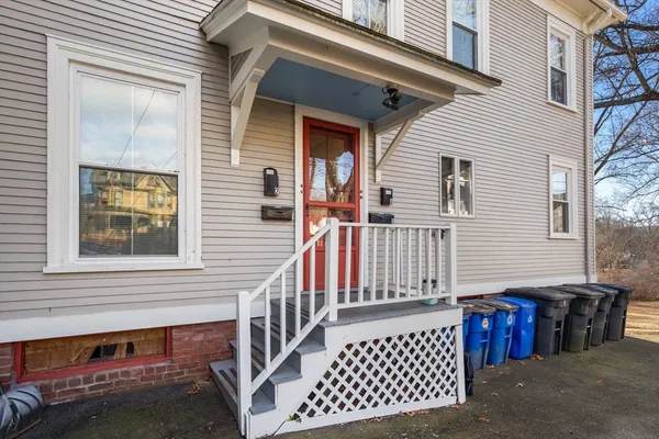 a view of a house with a wooden fence