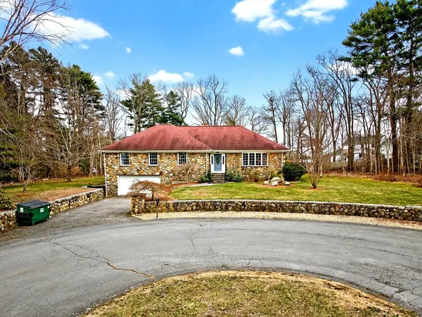 a view of a house with a yard and sitting area