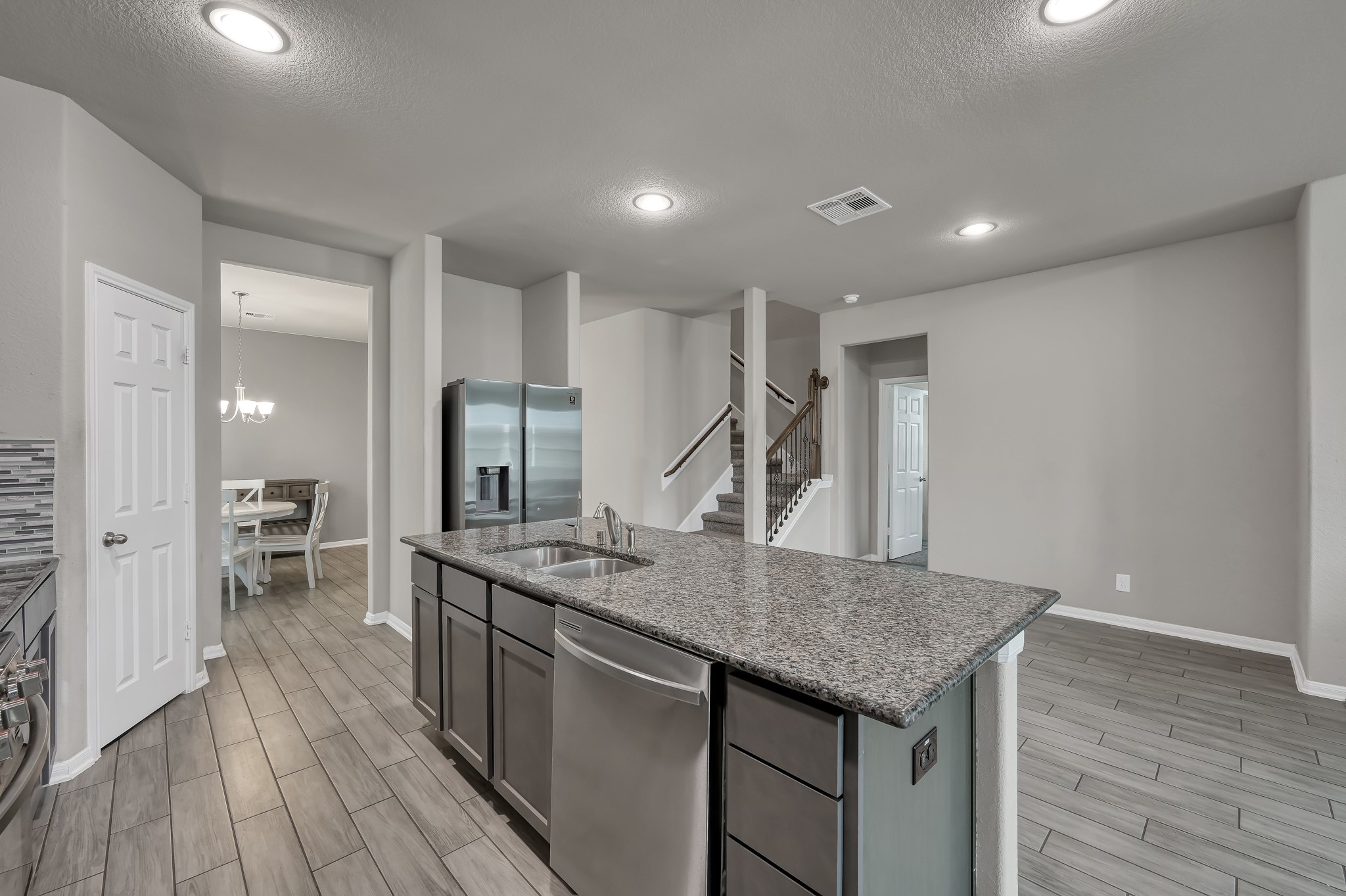 29211 Sequoia Tree Trail Spring, TX 77386 - Photo 4 of 32 a kitchen with center island and stainless steel appliances