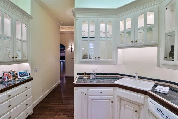 a kitchen with granite countertop a sink stove and cabinets