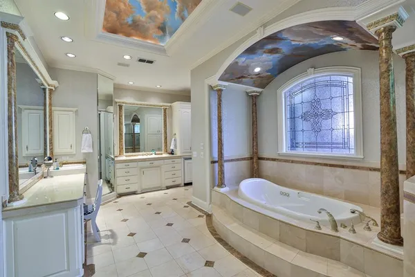 a bathroom with a tub sink and mirror