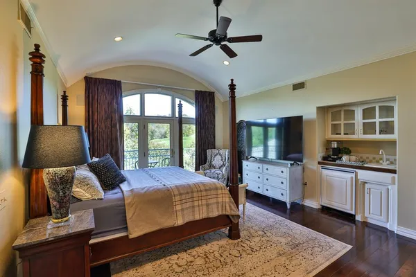 a bedroom with a bed couch and window