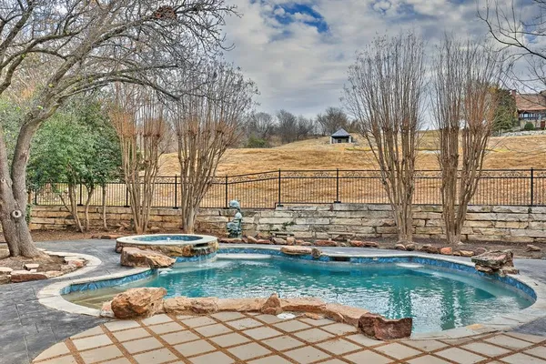 a view of a house with backyard fountain and sitting area