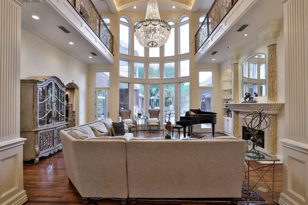 a living room with fireplace furniture and a chandelier