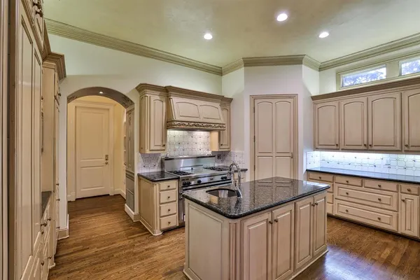 a kitchen with stainless steel appliances granite countertop a sink stove and refrigerator