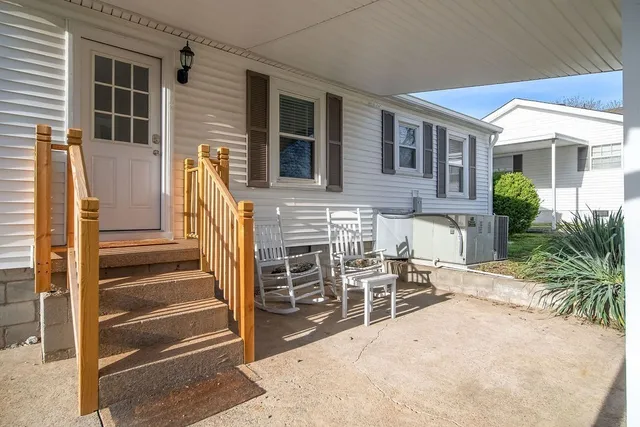 a view of a patio with table and chairs and potted plants