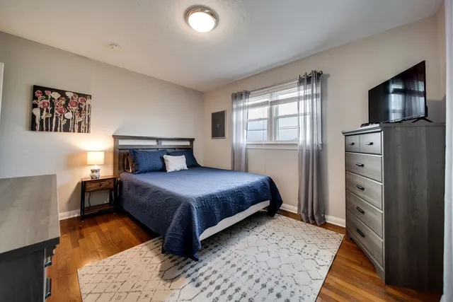 a bedroom with a bed and a television