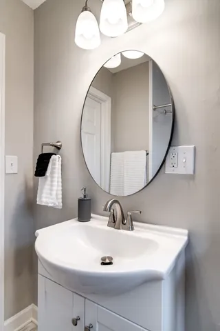 a bathroom with a sink and mirror