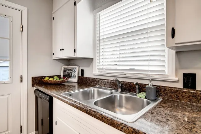 a kitchen with granite countertop a sink and a window