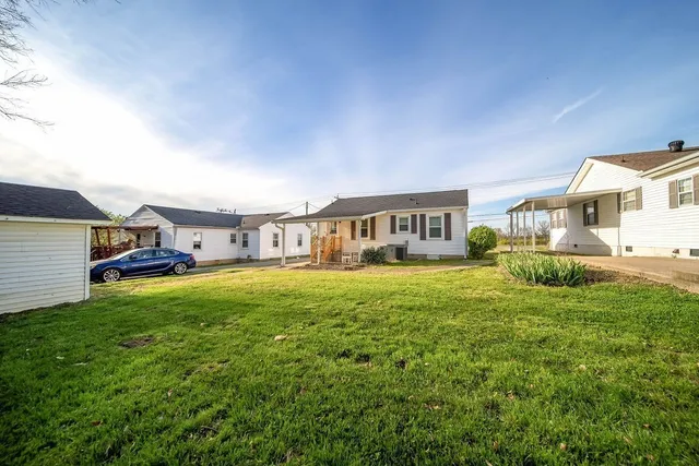 a front view of a house with a yard table and chairs