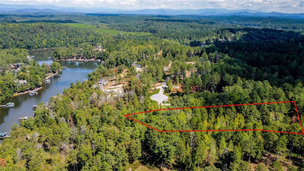 Lot 30 Harbor Point Seneca, SC 29672 - Photo 9 of 12 A verdant, tree-filled lot awaits, boasting convenient access to a picturesque lake.