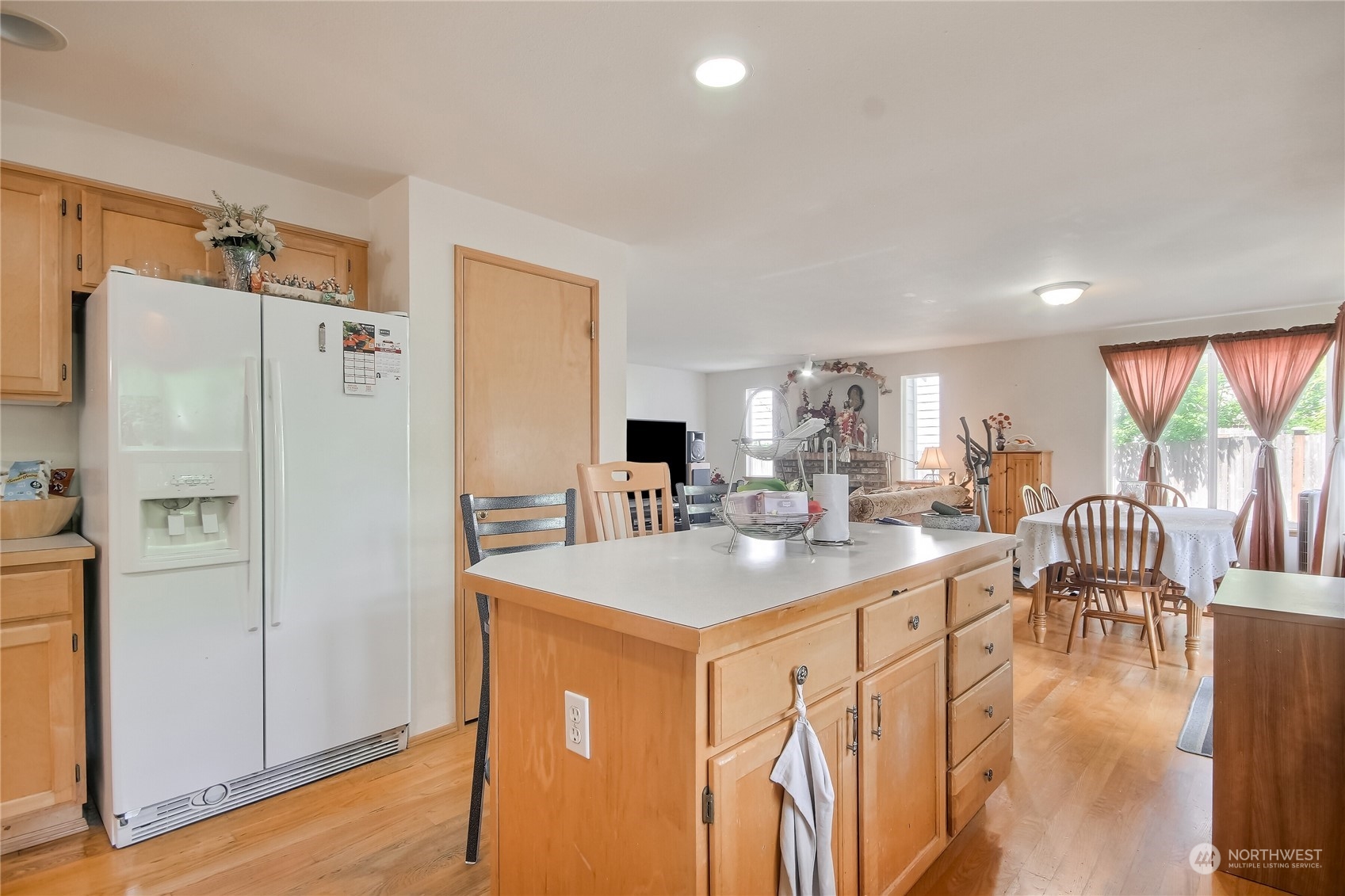 19910 142nd Place Southeast Renton, WA 98058 - Photo 12 of 38 a kitchen with stainless steel appliances granite countertop a refrigerator a stove and a refrigerator with wooden floor
