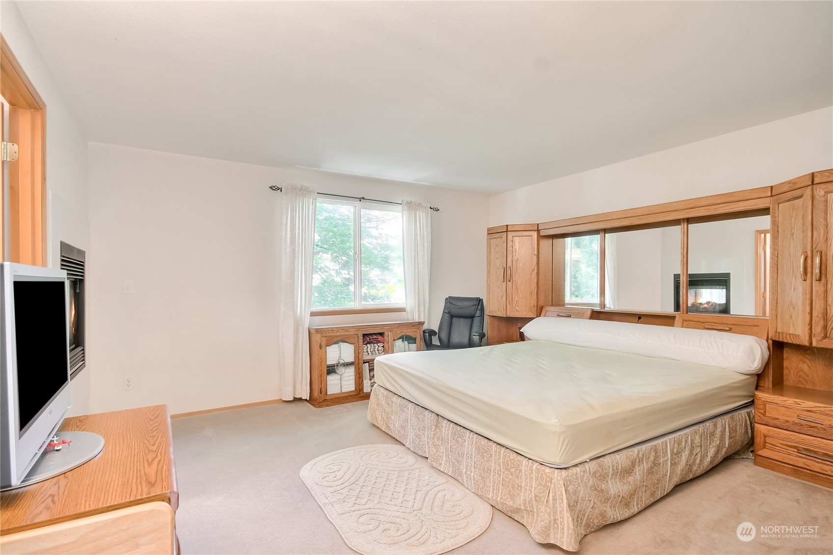 19910 142nd Place Southeast Renton, WA 98058 - Photo 17 of 38 a bedroom with a bed and a flat screen tv