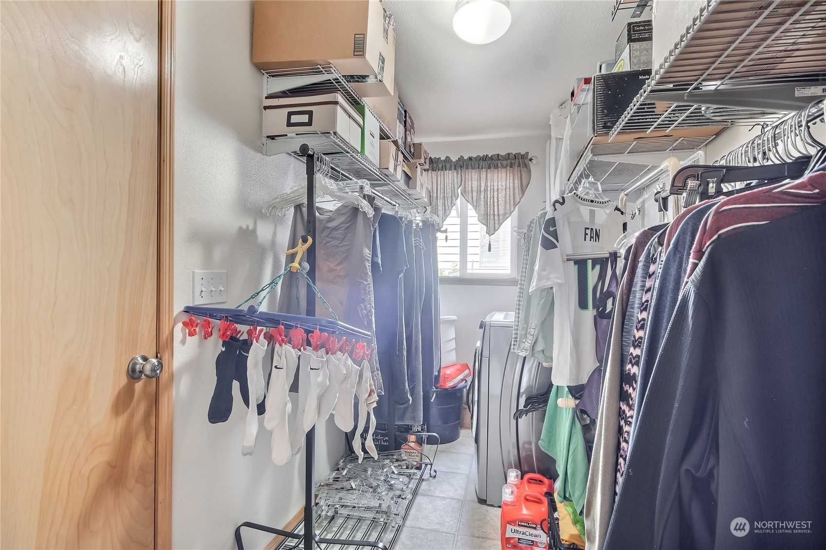 19910 142nd Place Southeast Renton, WA 98058 - Photo 27 of 38 a view of walk in closet with clothes and shoes