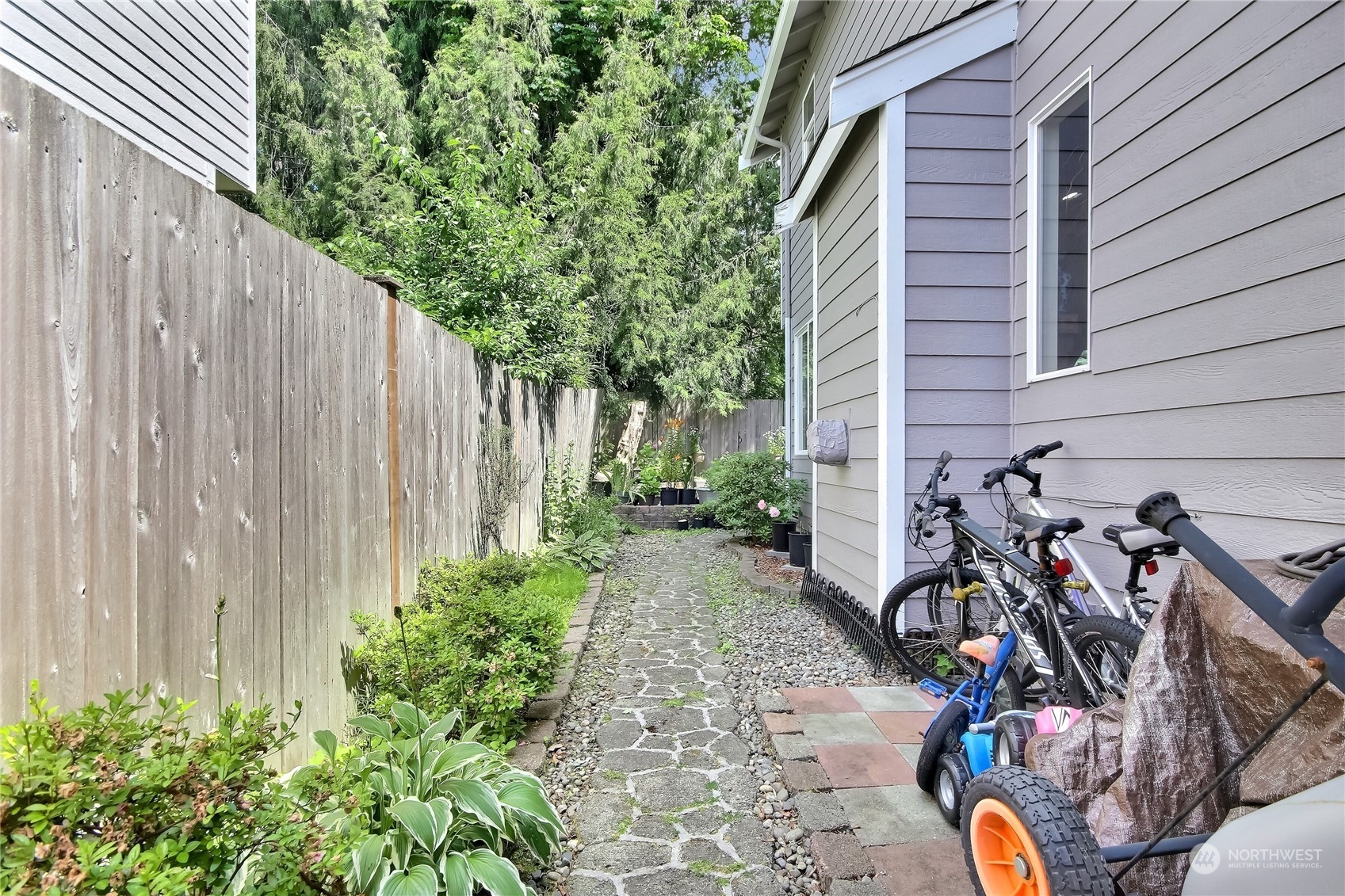 19910 142nd Place Southeast Renton, WA 98058 - Photo 29 of 38 a view of a backyard with plants and a bench