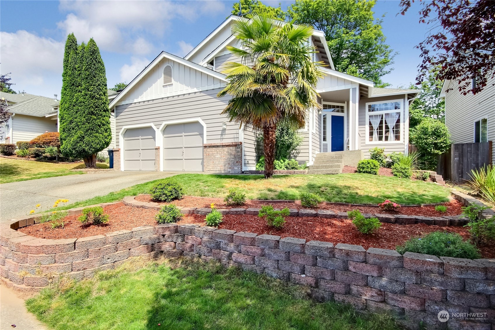 19910 142nd Place Southeast Renton, WA 98058 - Photo 4 of 38 a front view of a house with garden